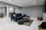 Basement living space with TV, Sofa, and bonus table for games or snacks 